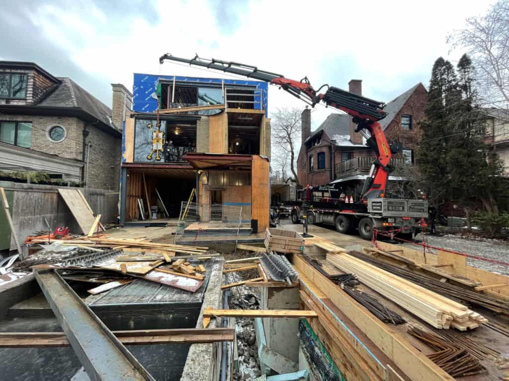 Lifting a glass window into place on a new home