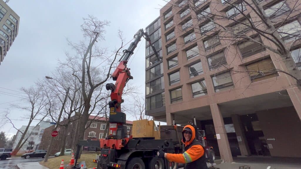 Using a knuckle crane to bring a large dining room set through an apartment building window