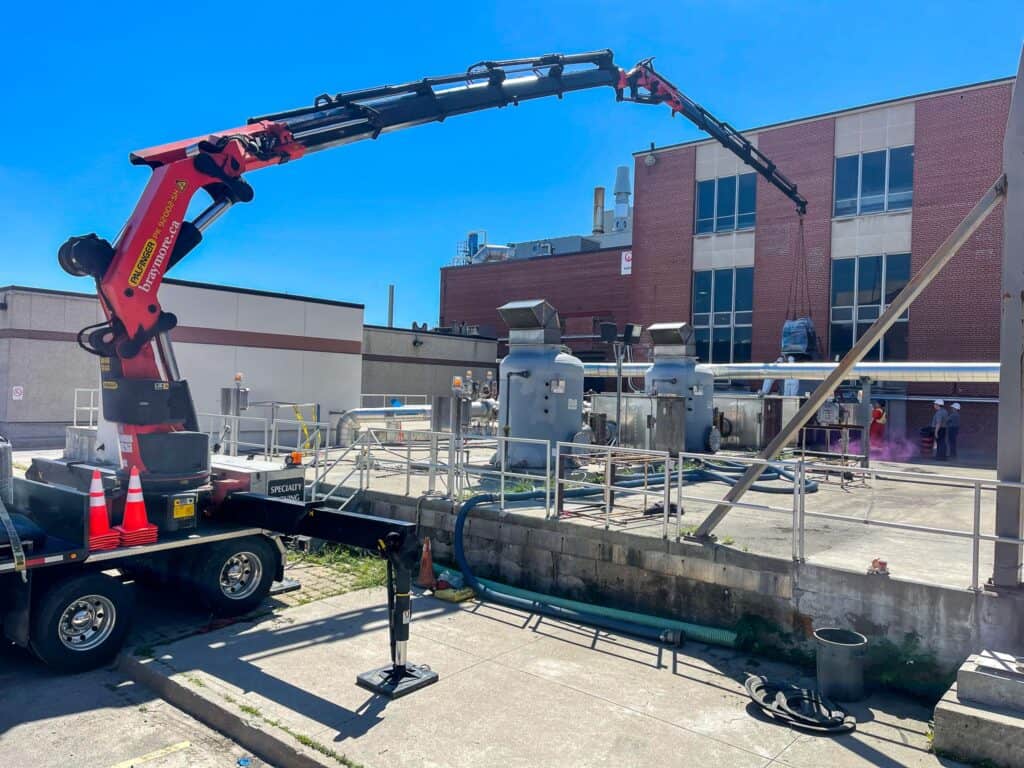 Using crane to lift skids of material into hard to reach places