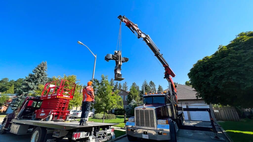 Using crane to place sculpture at an entry way