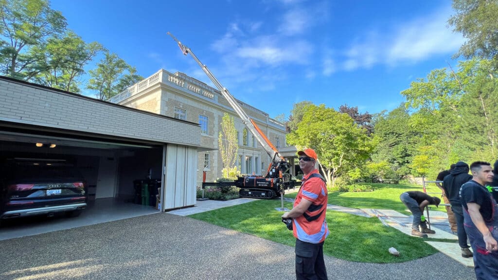 Using a spider crane to lift items up onto a roof or balcony