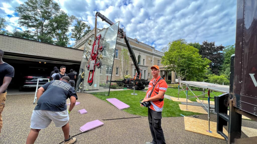 Craning a large custom glass window to the third floor of a custom home in Toronto