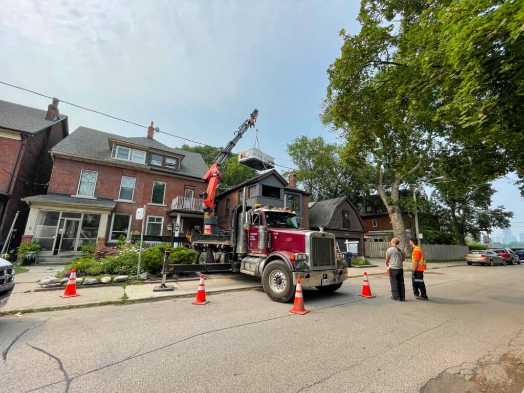 Parked in a very small driveway lifting a swim spa over some power lines and into a back yard.