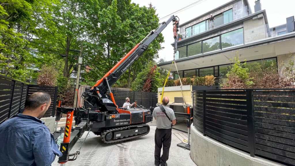 Spider crane using a ramp to get in close to lift some building materials into a home renovation.