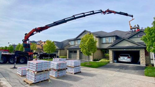 Crane shingles onto roof